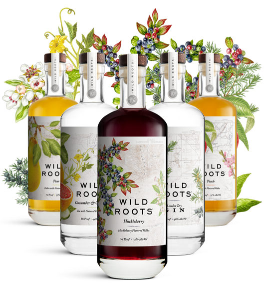 Five bottles of Wild Roots gin and vodka with floral and botanical designs on their labels against a white background.