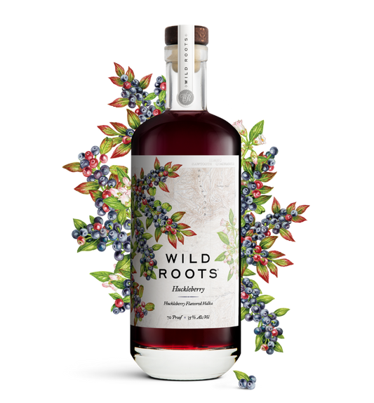 Bottle of Wild Roots Huckleberry vodka with a decorative arrangement of berries on a white background