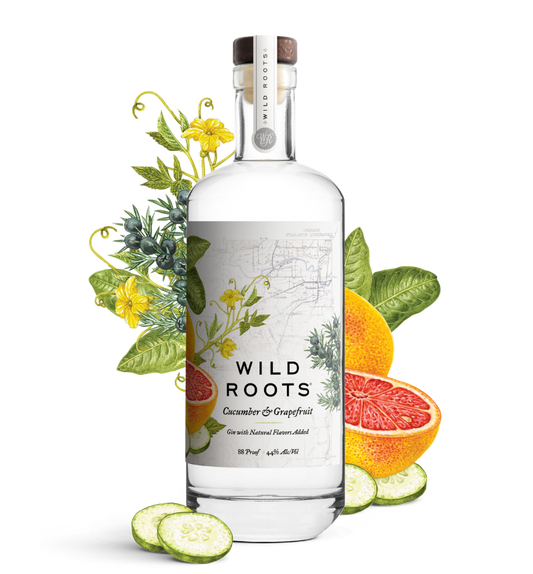 Bottle of Wild Roots cucumber and grapefruit gin with botanicals and fruits on a white background