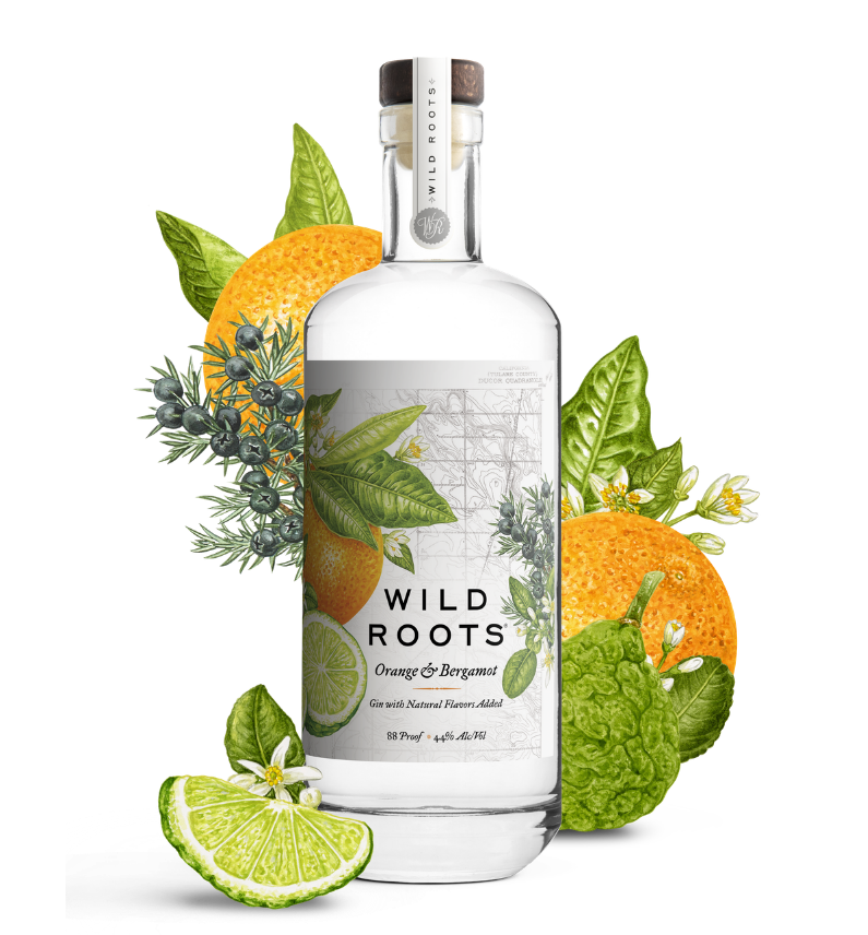 Bottle of Wild Roots Orange & Bergamot gin with botanicals on a white background