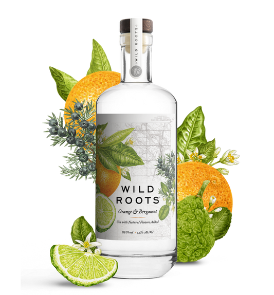 Bottle of Wild Roots Orange & Bergamot gin with botanicals on a white background