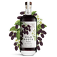 Bottle of Wild Roots Marionberry vodka with marionberries and green leaves on a white background